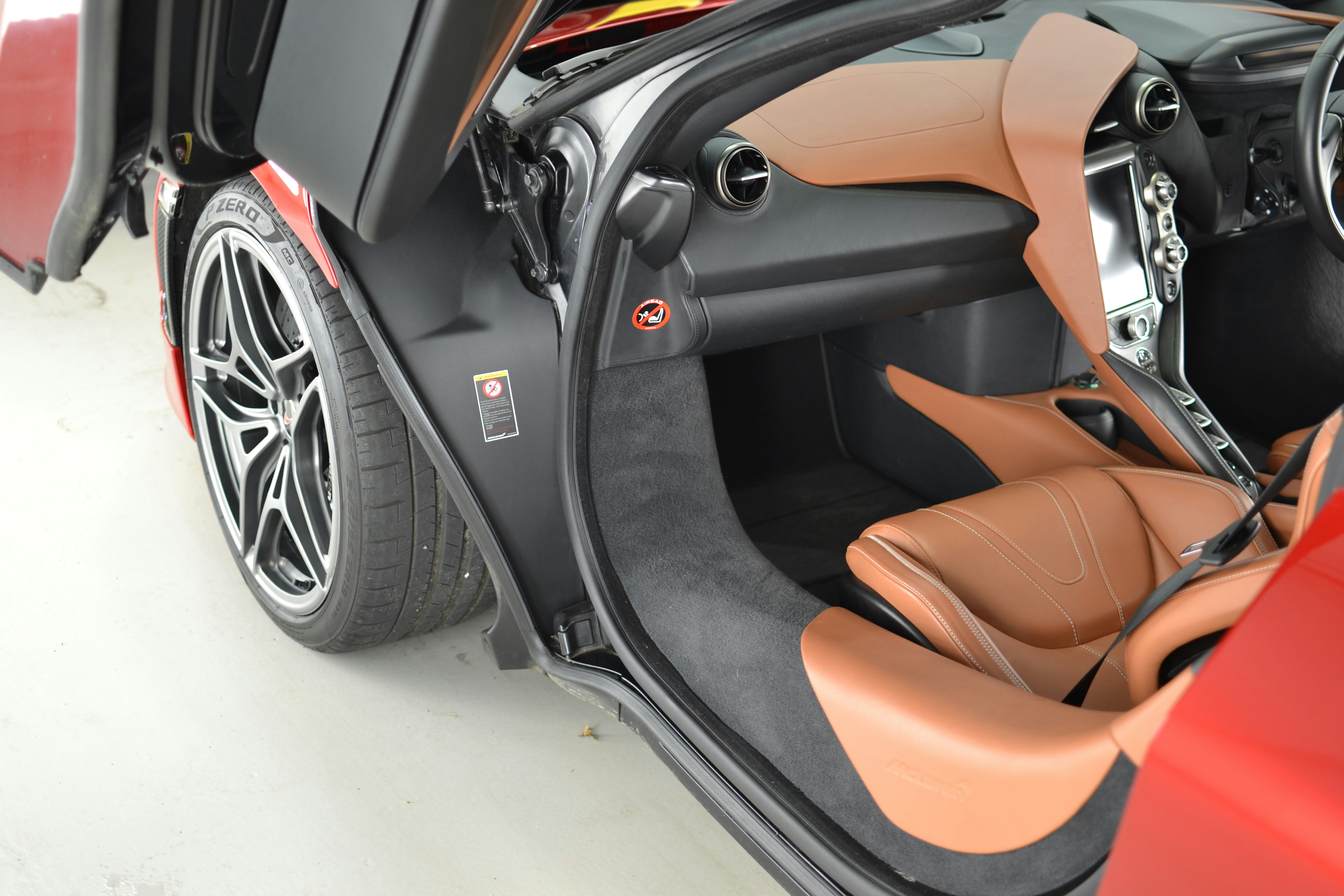 the interior of a sports car with the door open