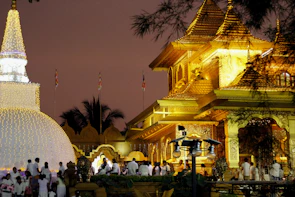 The temple glowing softly in the evening light, with marigold decorations for Guru Poornima.