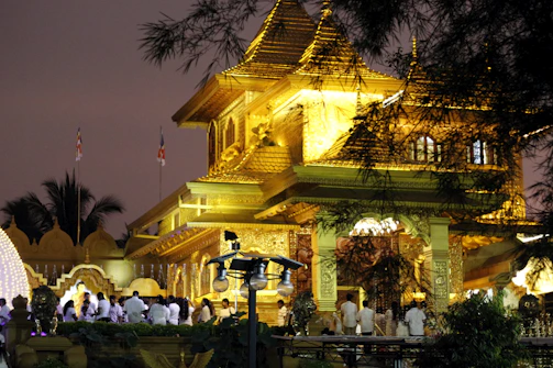 A serene temple entrance adorned with glowing diya lamps at dusk.