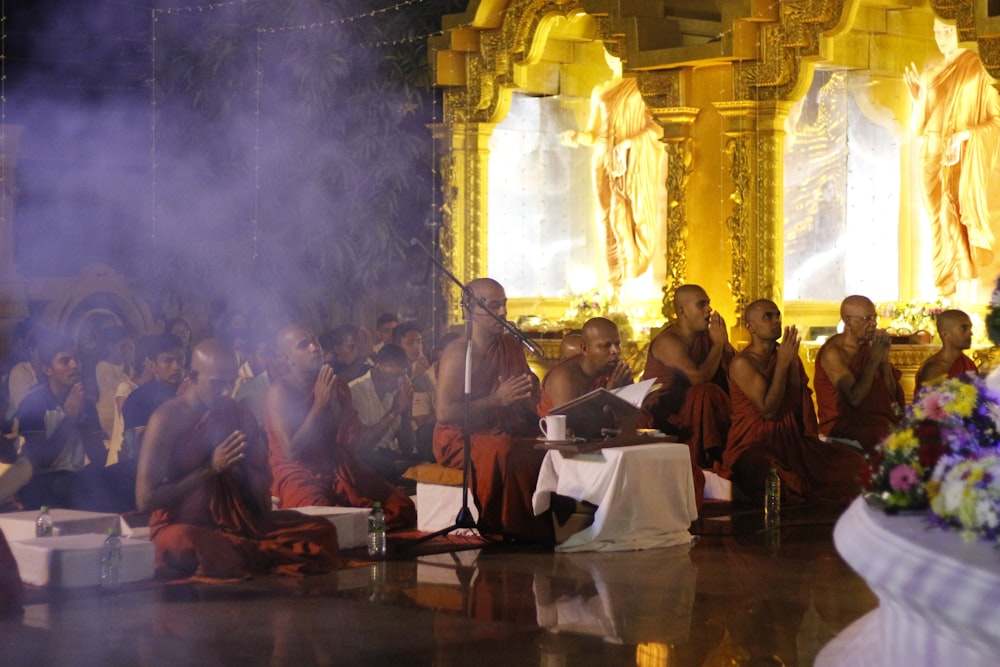 a group of people sitting in front of a stage