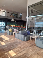 A warm community gathering in a modern, minimalist space with navy blue and gold accents.