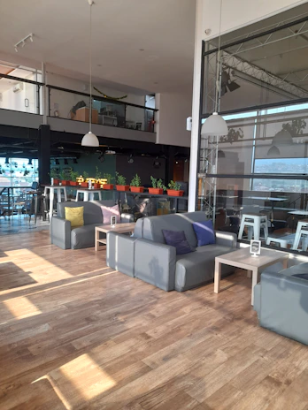 A warm community gathering in a modern, minimalist space with navy blue and gold accents.