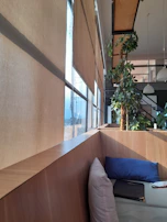 Warm, inviting office corner with soft cushions and greenery, the perfect private space for a virtual session.