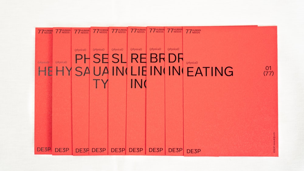 a set of five pieces of red paper with black lettering