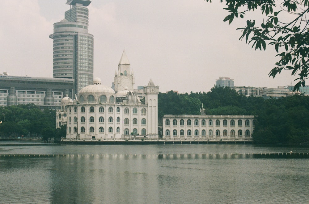 a large white building sitting on top of a lake