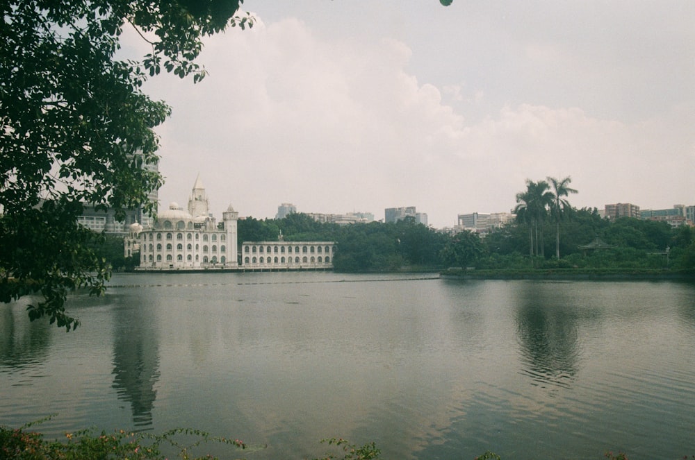 a large white building sitting on top of a lake