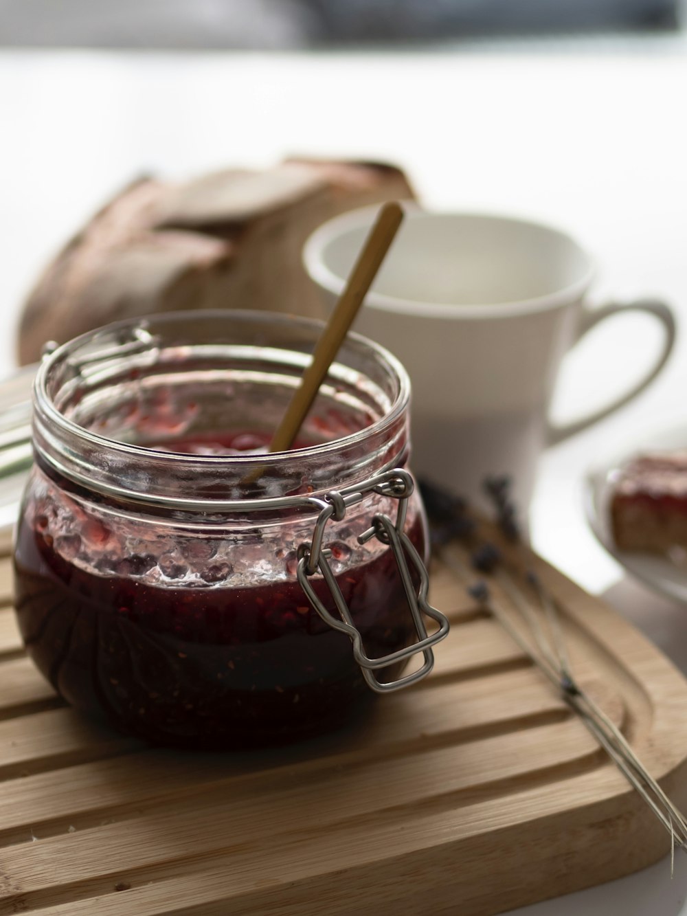 un frasco de mermelada encima de una tabla de cortar de madera