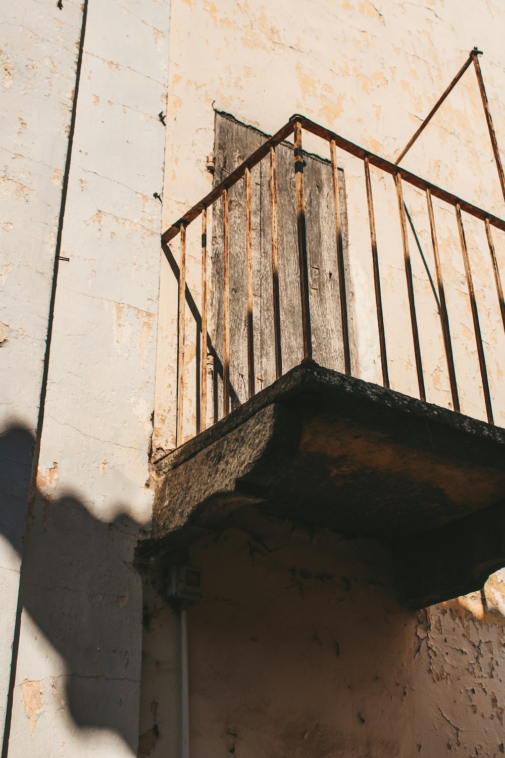 a balcony with a rusted iron railing