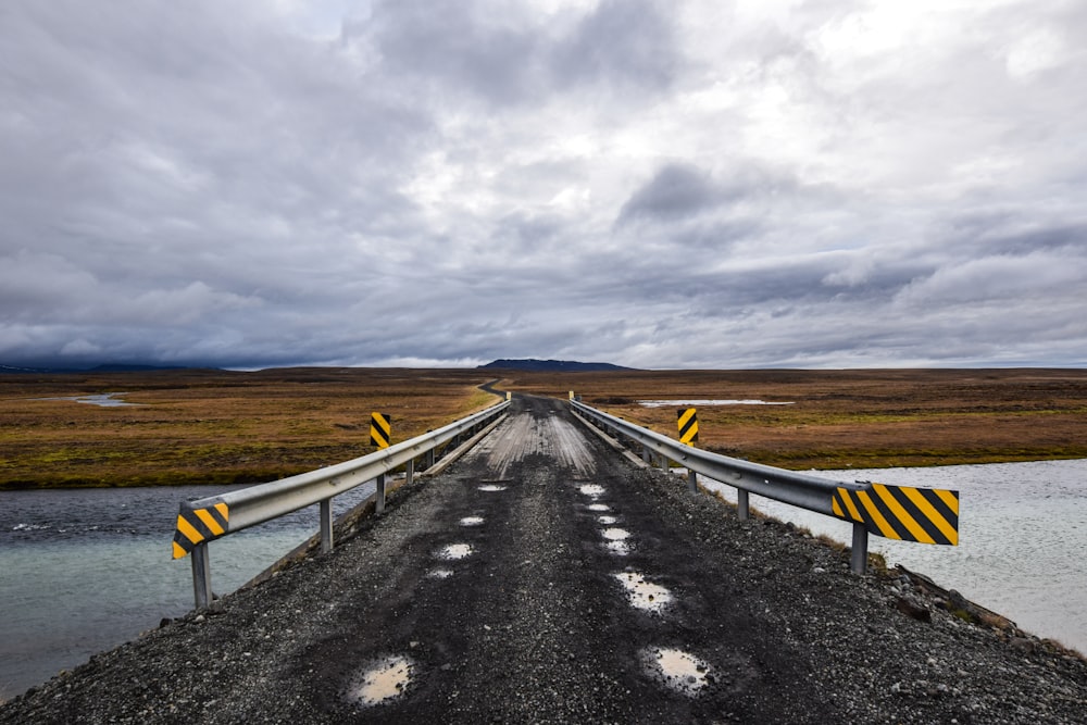 a bridge over a body of water on a cloudy day