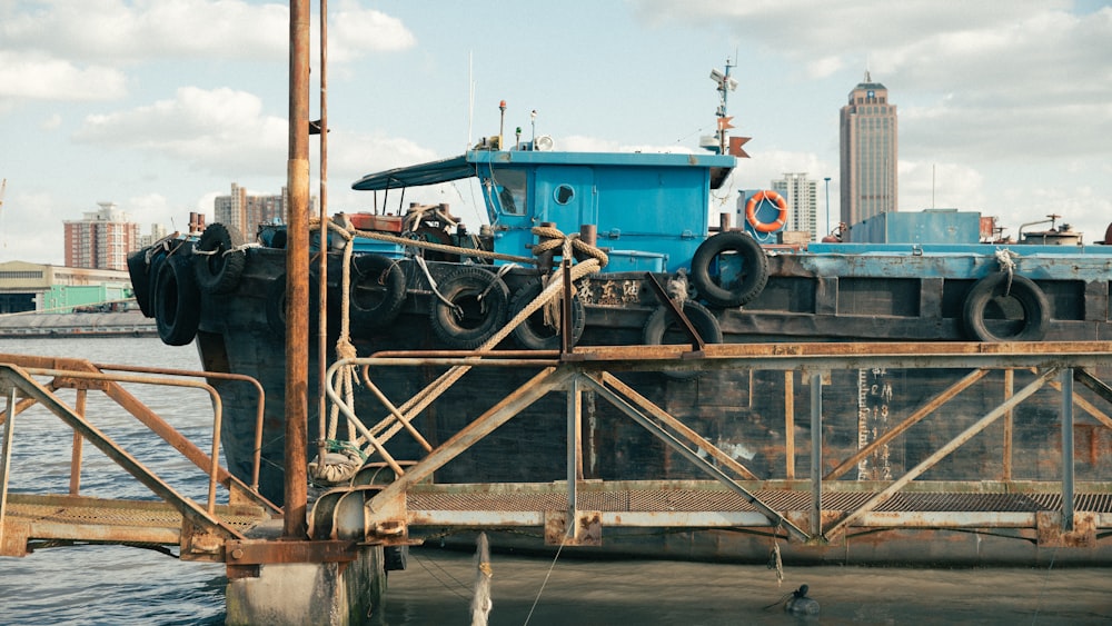 a large blue boat sitting on top of a pier