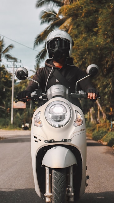 a man riding on the back of a white motorcycle