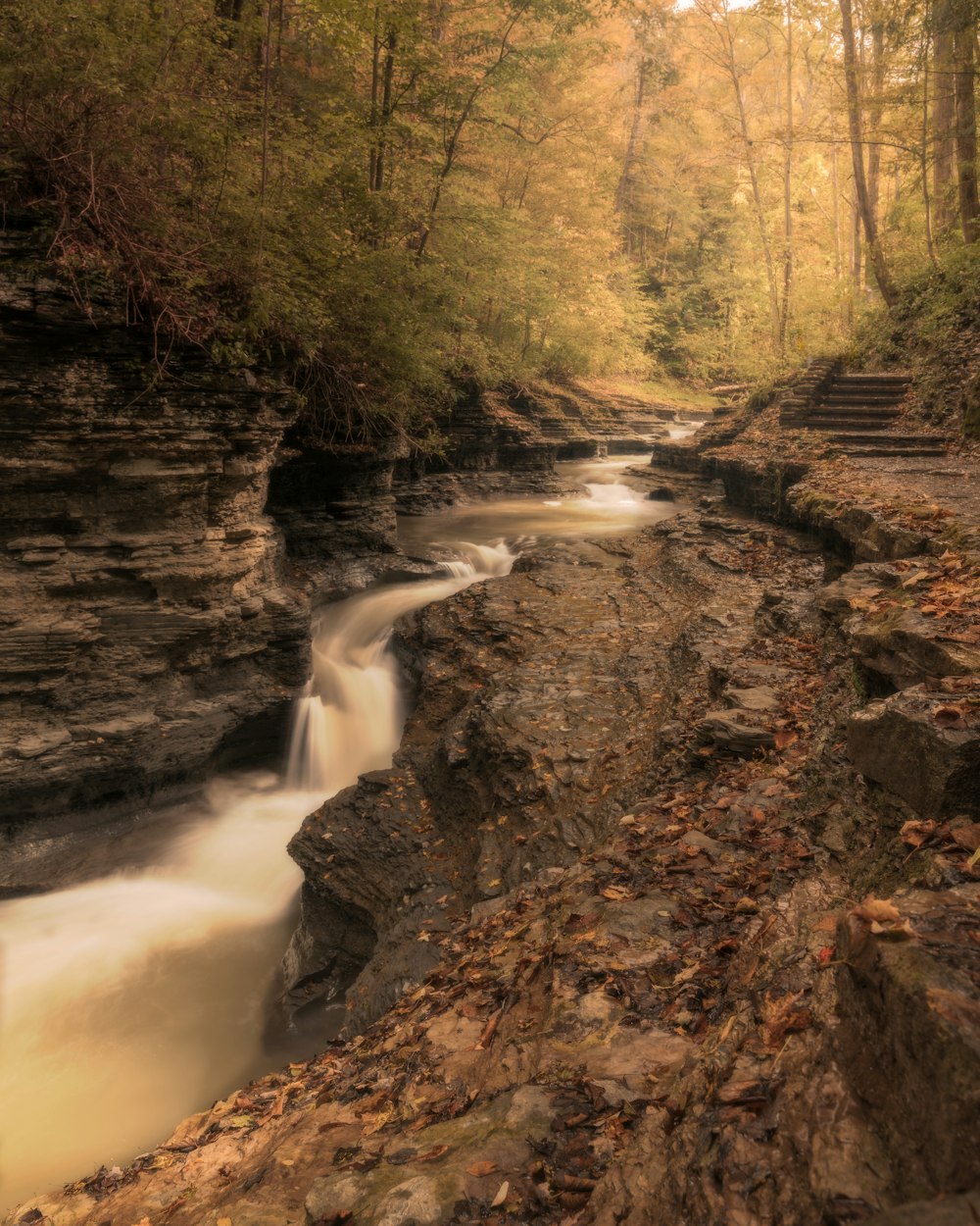 a waterfall going over a body of water