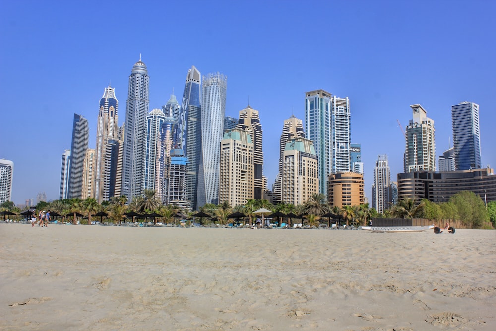 a beach with a lot of tall buildings in the background