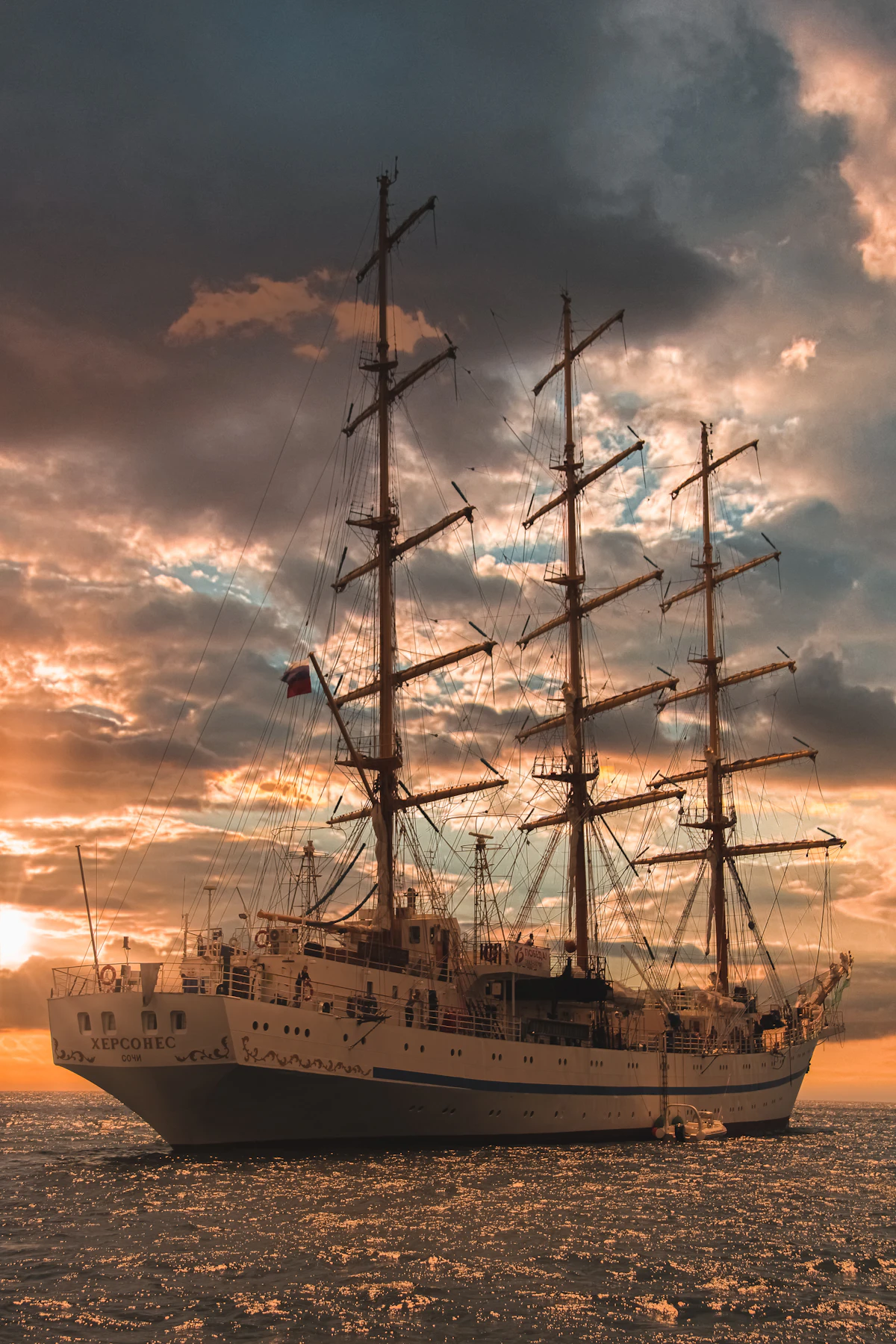Cruise ship at sea near the coast at sunset