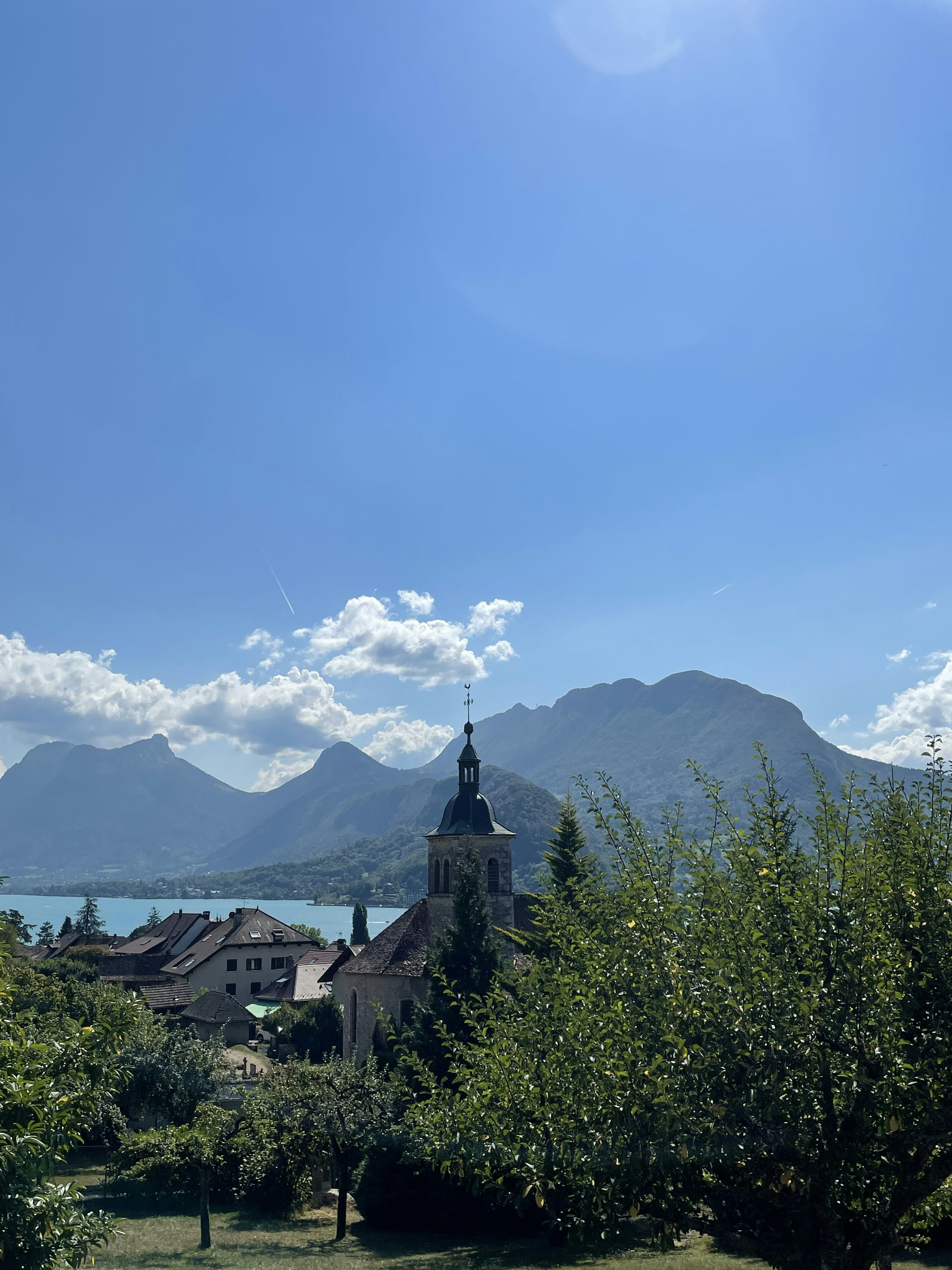a church with a steeple on a sunny day