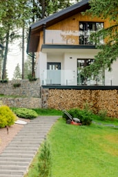 House with stone pathway in the Batak mountains, lawn freshly mowed and monitored by Hedgie Wilder