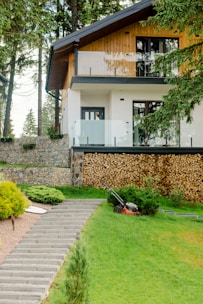 House with stone pathway in the Batak mountains, lawn freshly mowed and monitored by Hedgie Wilder