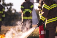 a group of firefighters standing around a fire hydrant