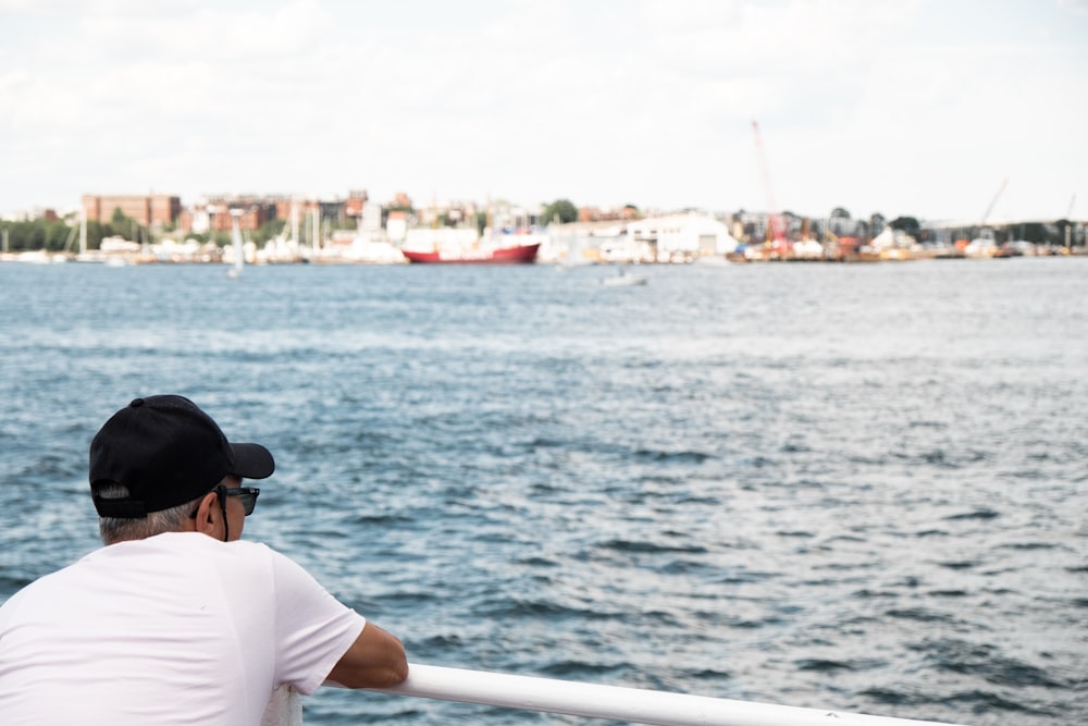 a man sitting on a boat looking out over the water