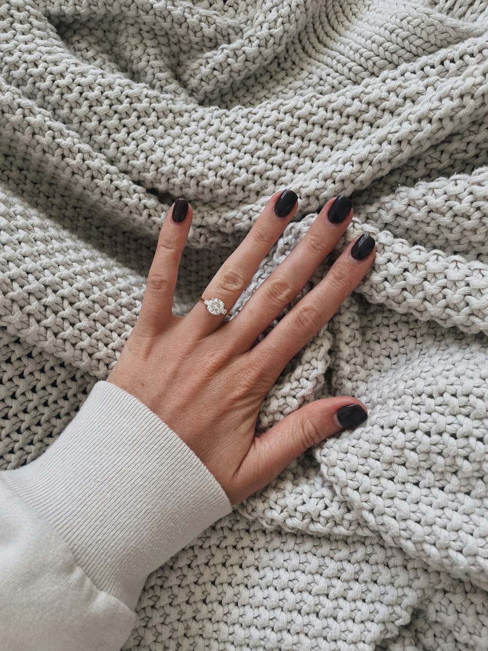 a woman's hand on a blanket