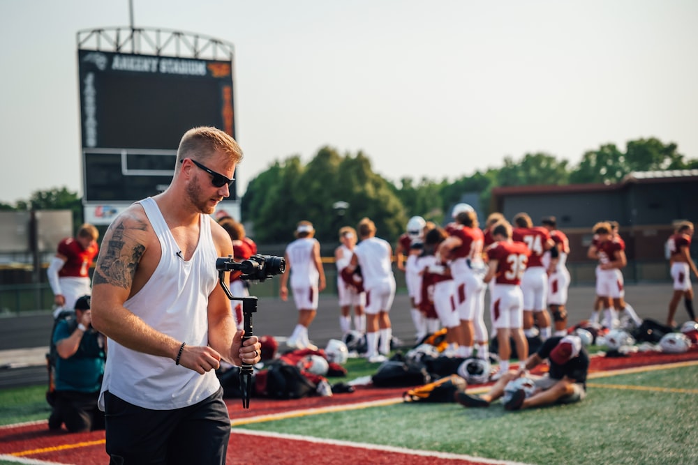 a man with a camera on a football field