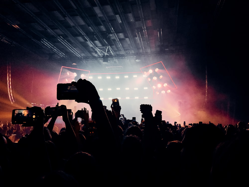 a crowd of people standing around a stage