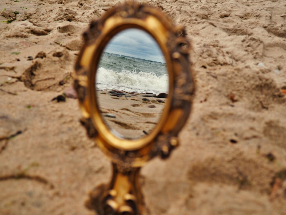 a mirror that is sitting in the sand