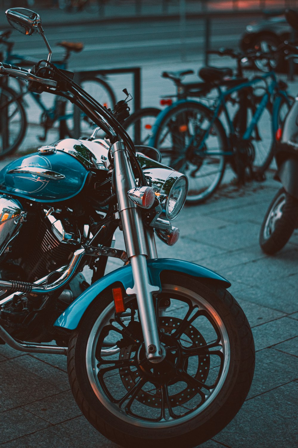 a blue motorcycle parked on the side of a road