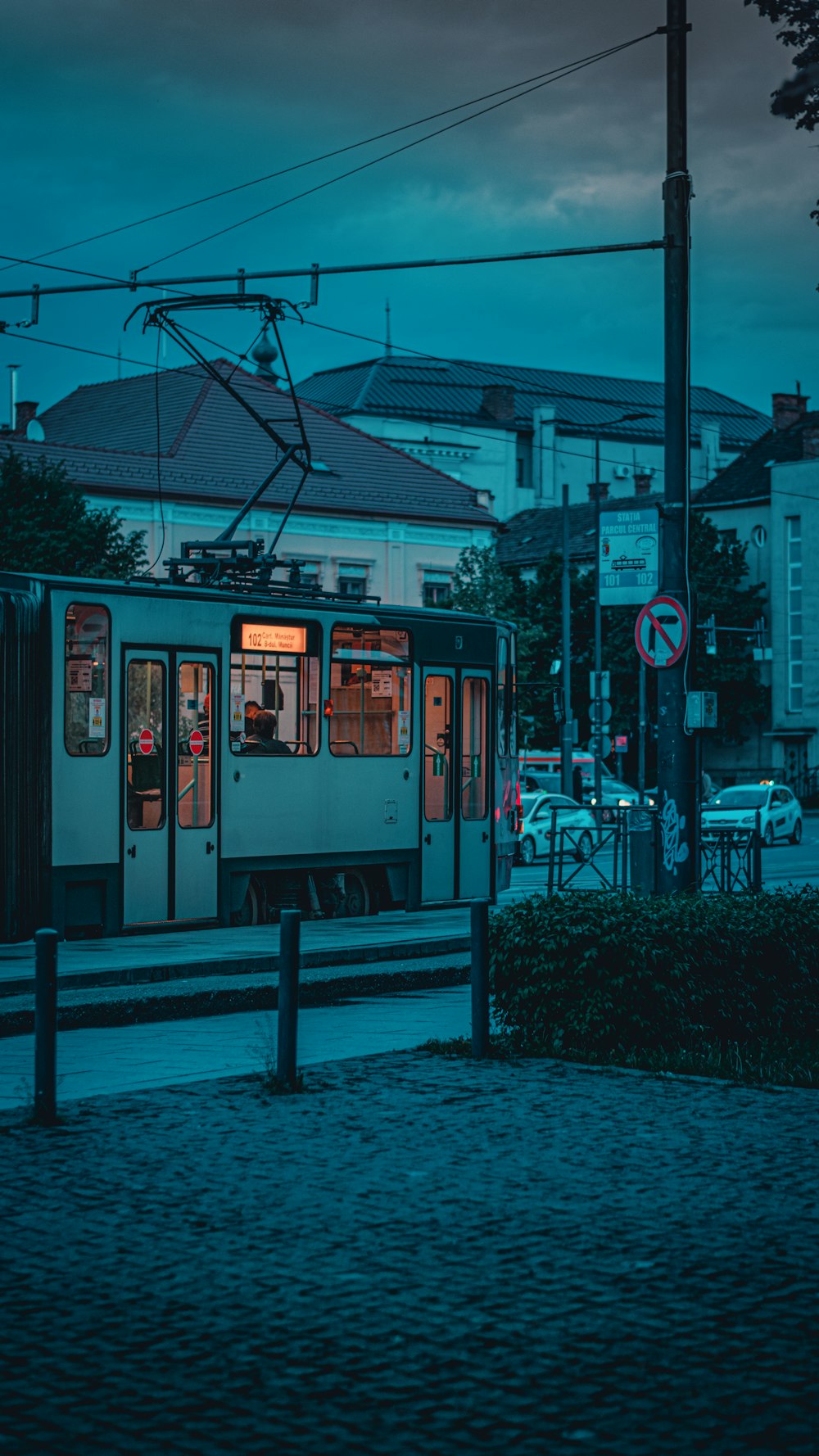 a train traveling down tracks next to a street