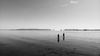 a couple of people standing in the water
