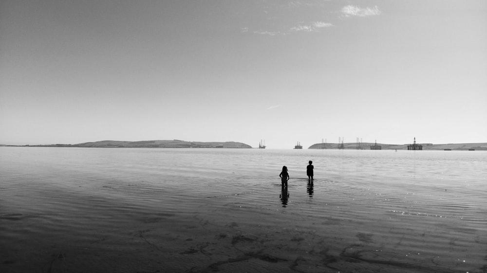 a couple of people standing in the water