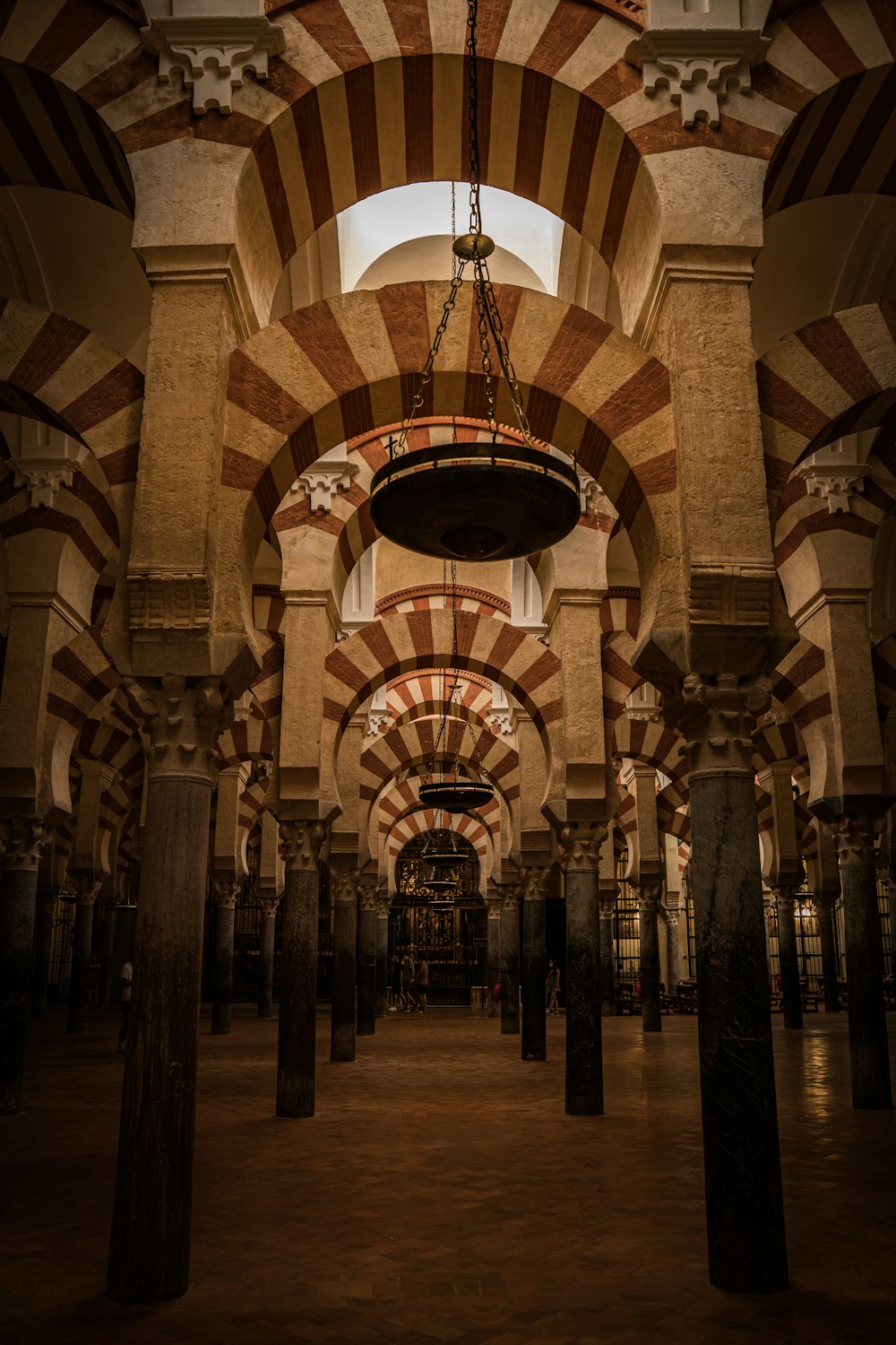 the inside of a building with columns and arches