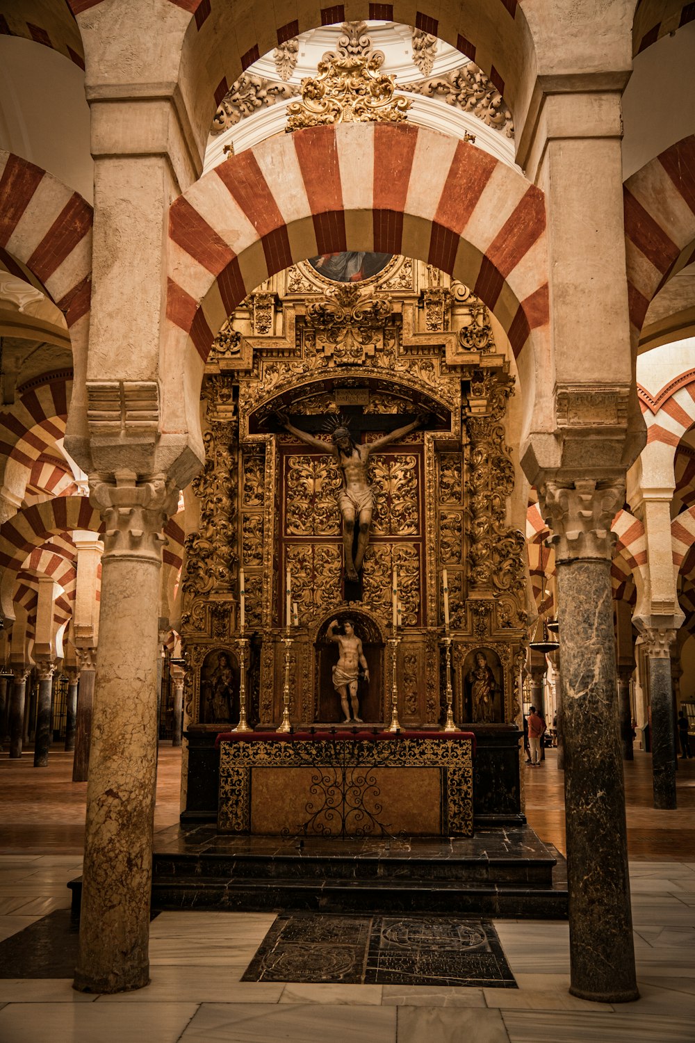 an ornate alter in a church with columns and arches