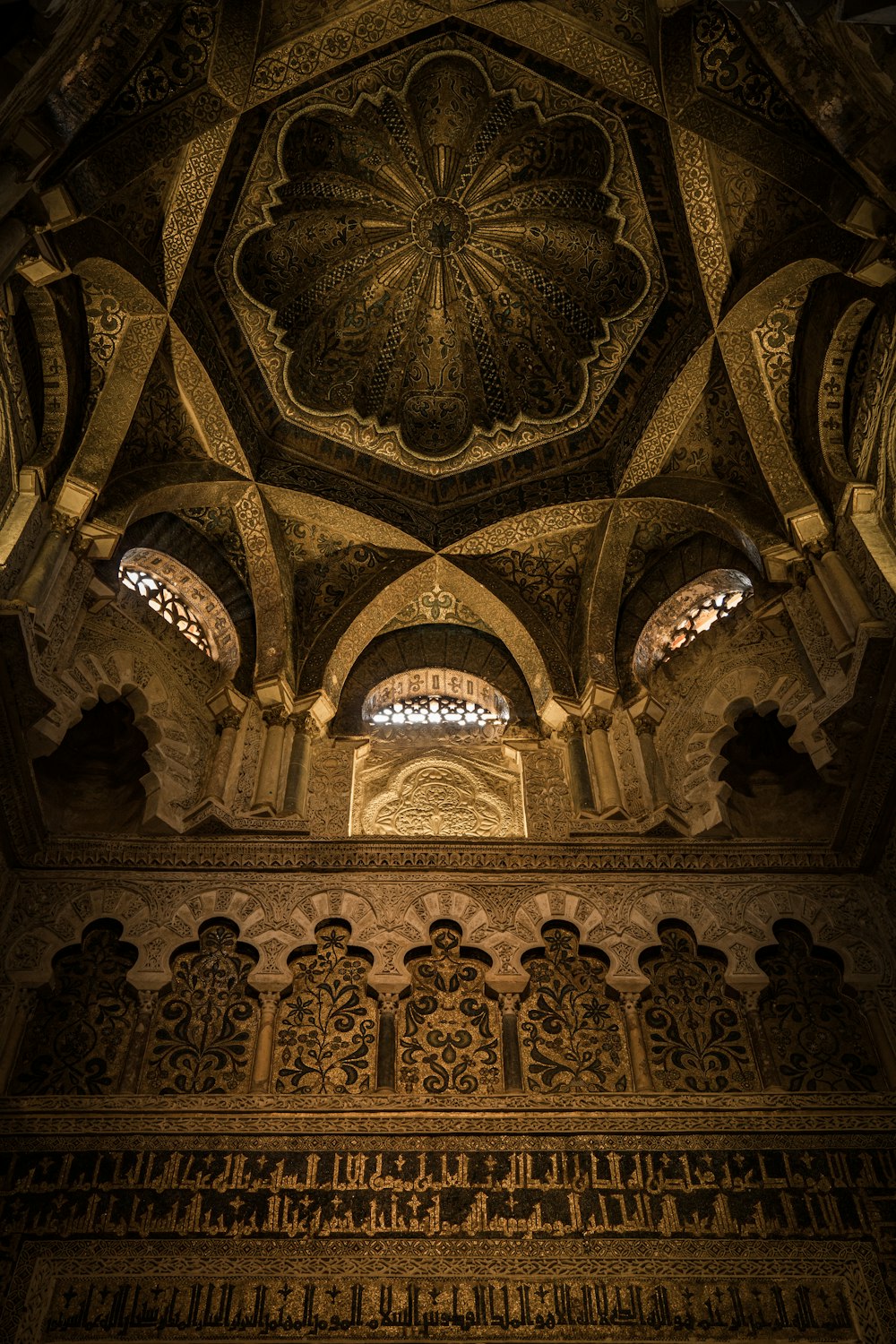 the ceiling of a building with intricate carvings