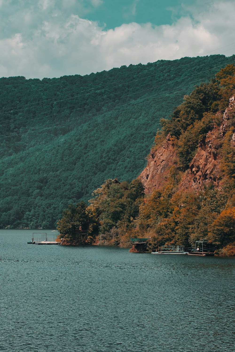 a body of water surrounded by a lush green hillside