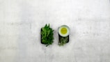 Lifestyle photo of a kitchen counter with bottles of woodpressed oils and fresh herbs