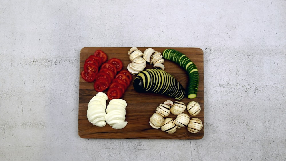 a cutting board topped with sliced up vegetables