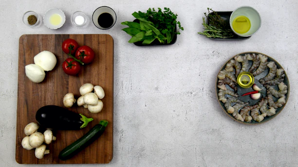 a wooden cutting board topped with lots of veggies