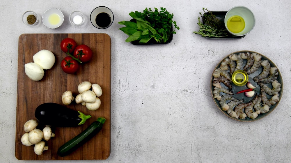 a wooden cutting board topped with lots of veggies