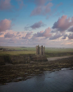 Ruins of a Crusader castle overlooking the landscape of the Holy Land at sunset.