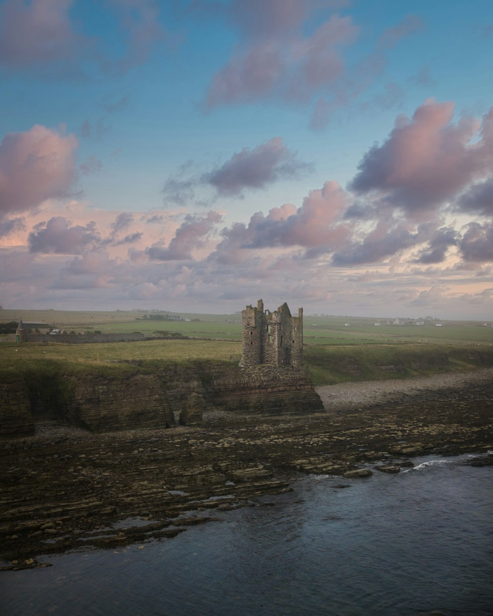 a large castle sitting on top of a lush green field