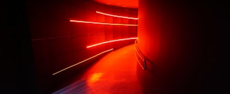 a long hallway with a red light coming from it