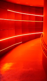 a long hallway with a red light coming from it