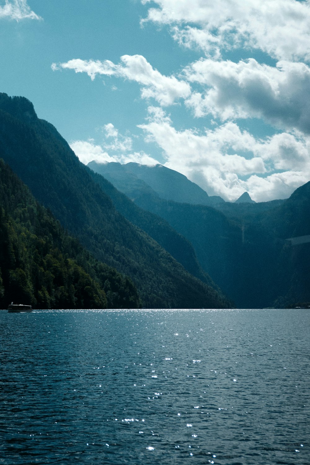 a body of water with mountains in the background