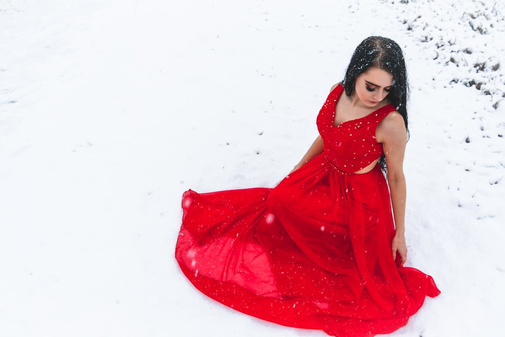 a woman in a red dress in the snow