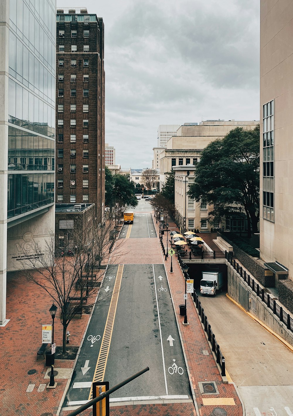 a view of a city street from the top of a building