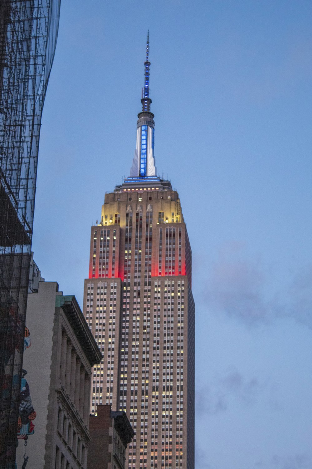 the empire building is lit up in red, white, and blue