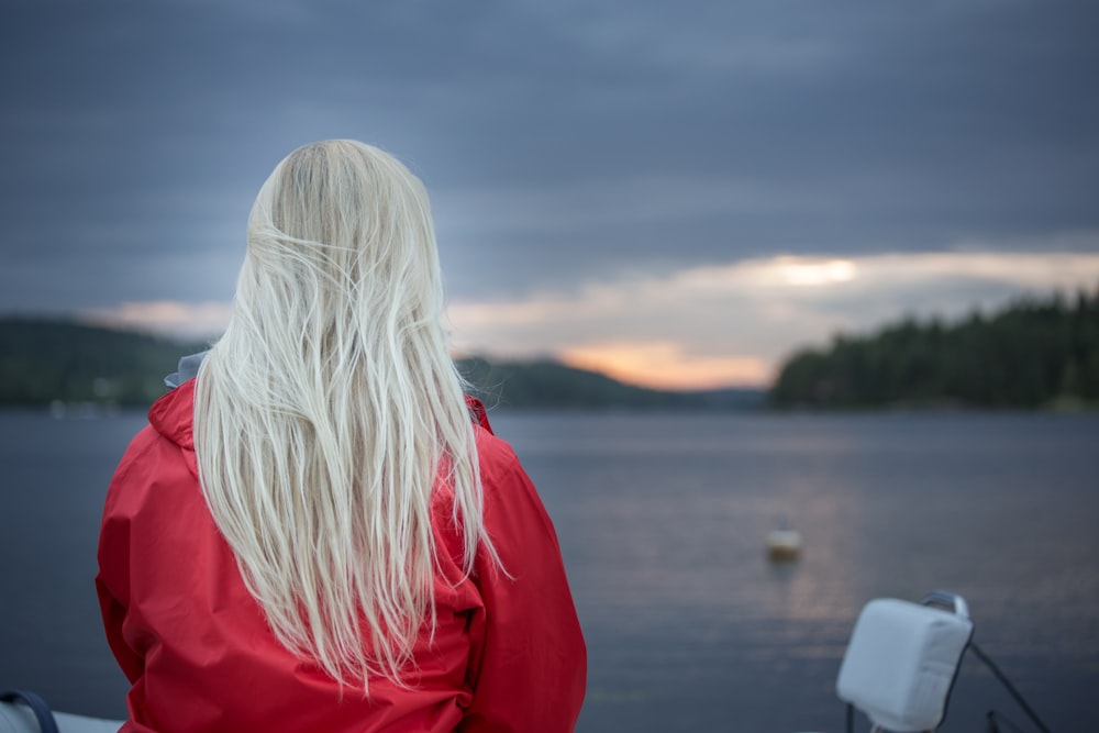 a woman with long white hair sitting on a boat