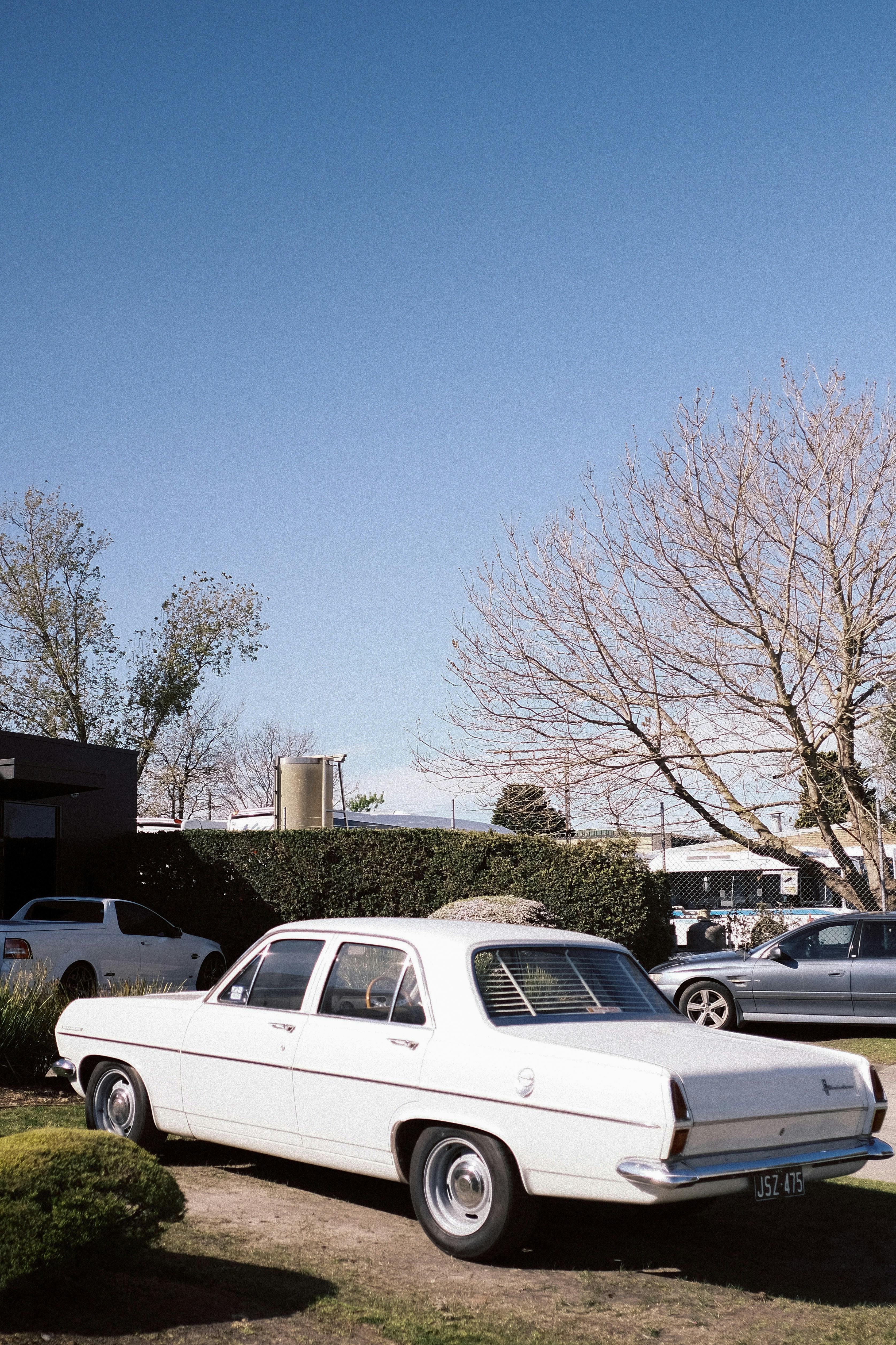 a white car is parked in a driveway