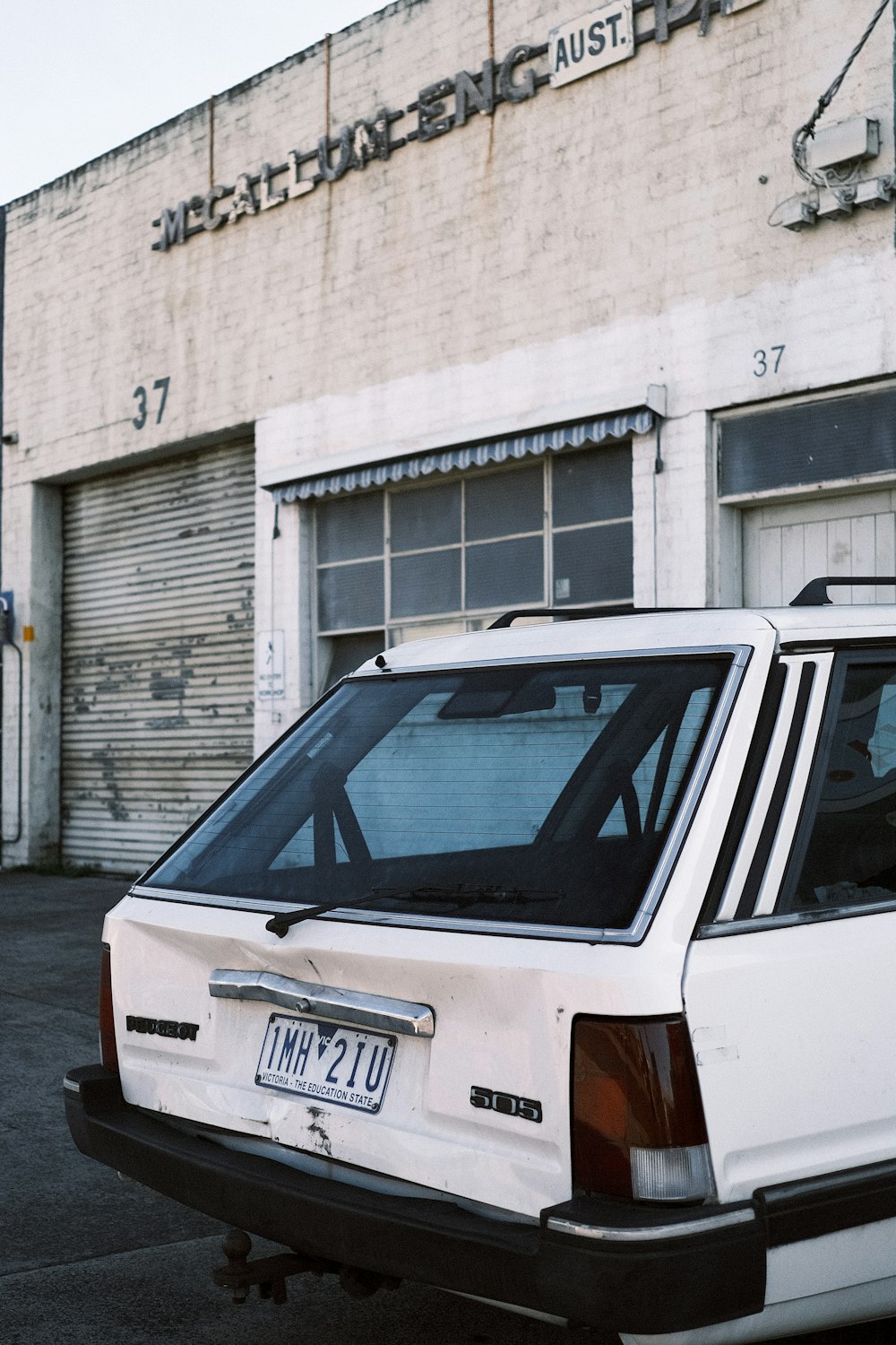 a white car parked in front of a building